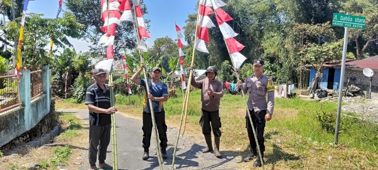 Bhabinkamtibmas Langke Rembong Bersama Lurah dan Warga Serentak Pasang Atribut Kemerdekaan